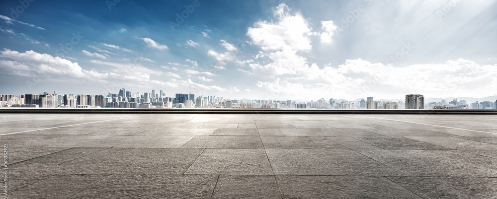 empty floor and cityscape of modern city against cloud sky