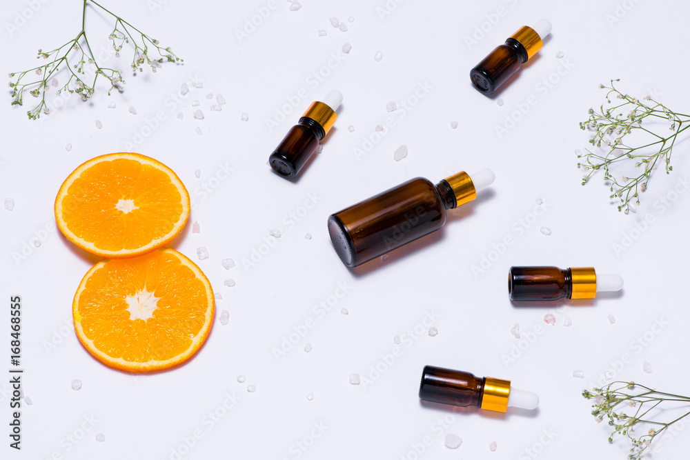 Branding mock-up. Natural essential oil, Cosmetic bottle containers with orange slices.