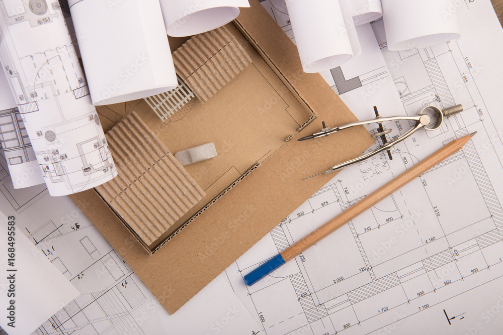 Workplace of architect - construction drawings, scale model and tools