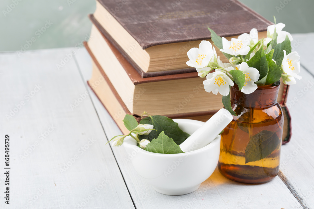 Spa concept - making essential oil with jasmine flowers