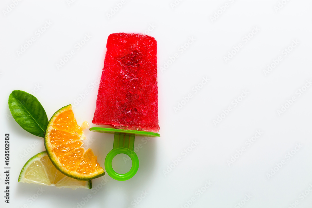 flat lay style of handmade ice cream with lime and orange fruit on white background.