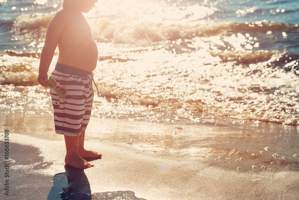 Baby boy are walking on the beach