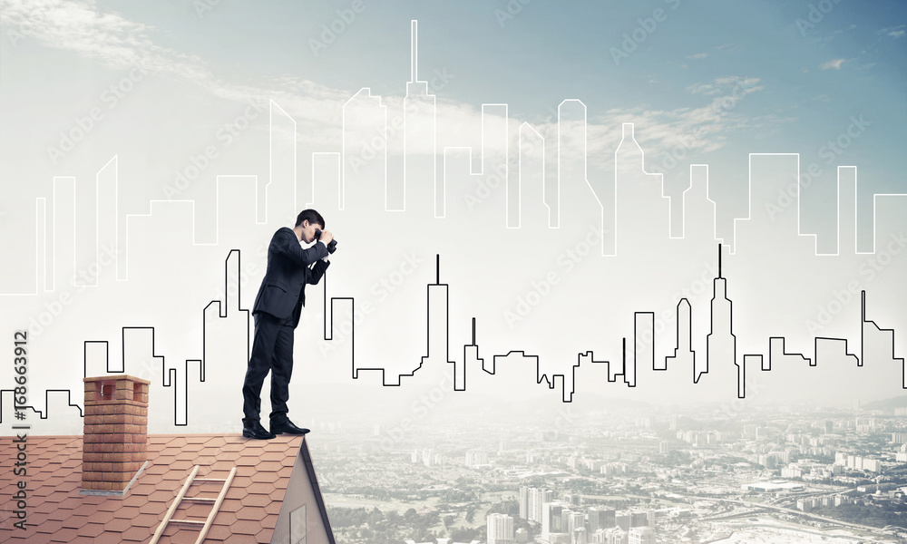 Businessman standing on roof and looking in binoculars. Mixed me