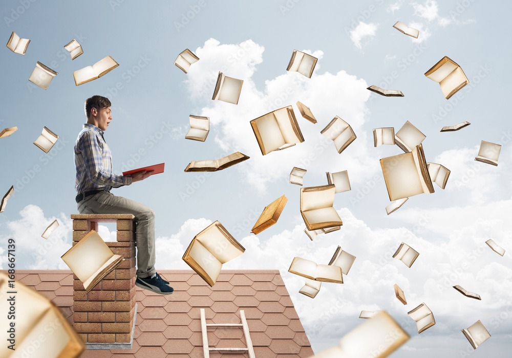 Man reading book and many of them flying in air