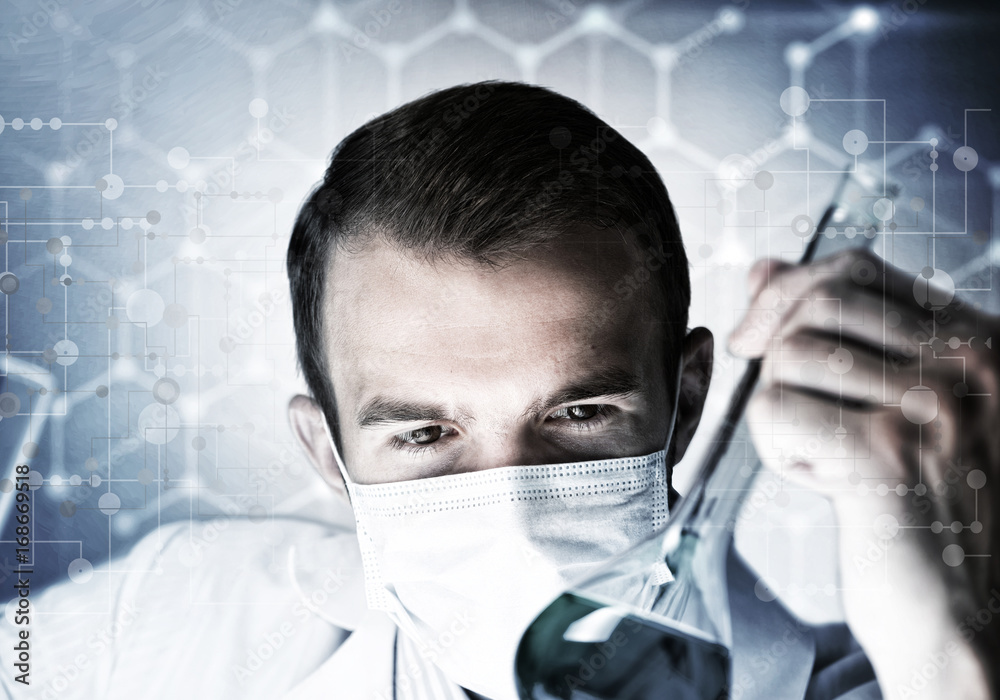 Portrait of concentrated male scientist working with reagents in laboratory