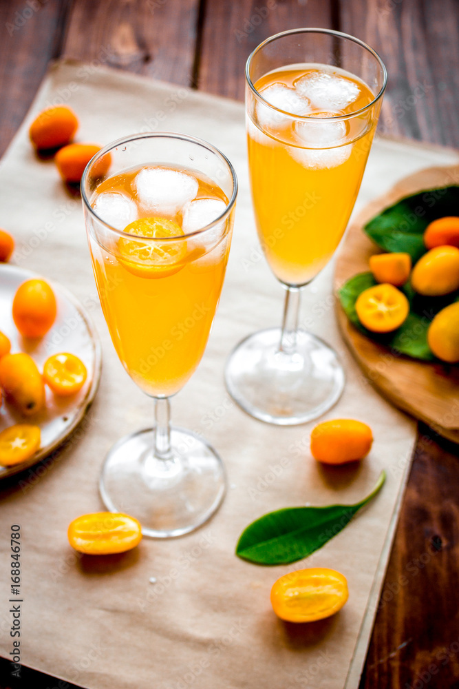 cocktail with kumquat on wooden background