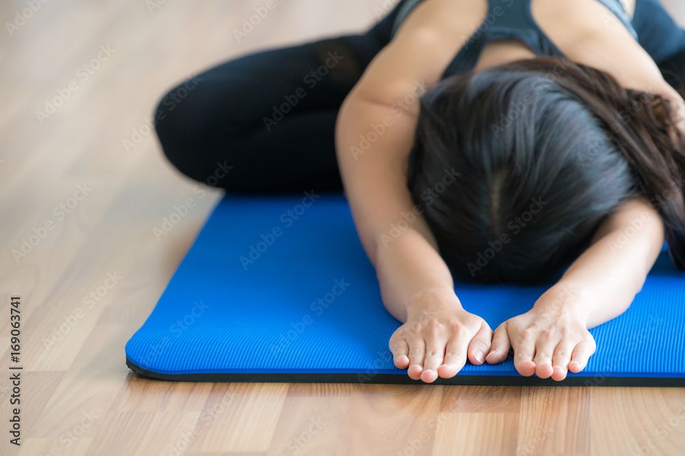 Woman practicing yoga pose in gym