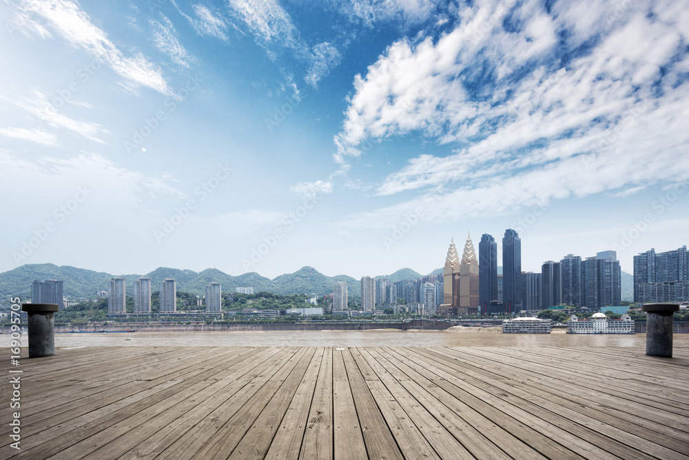 empty wooden floor and cityscape of modern city