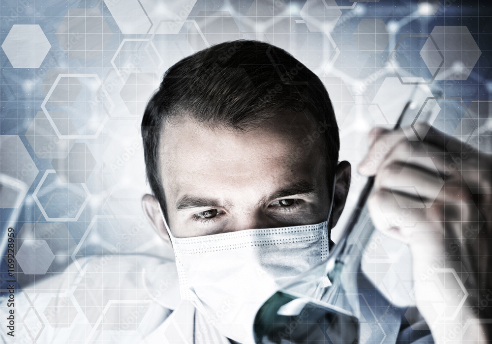 Portrait of concentrated male scientist working with reagents in laboratory