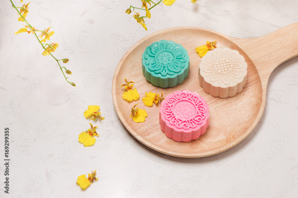 Traditional mooncakes on table setting. Snowy skin mooncakes. Chinese mid autumn festival foods.