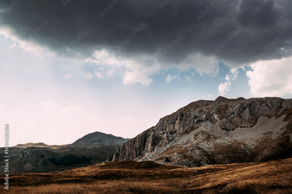 Stormy clouds in a blue sky over the mountains