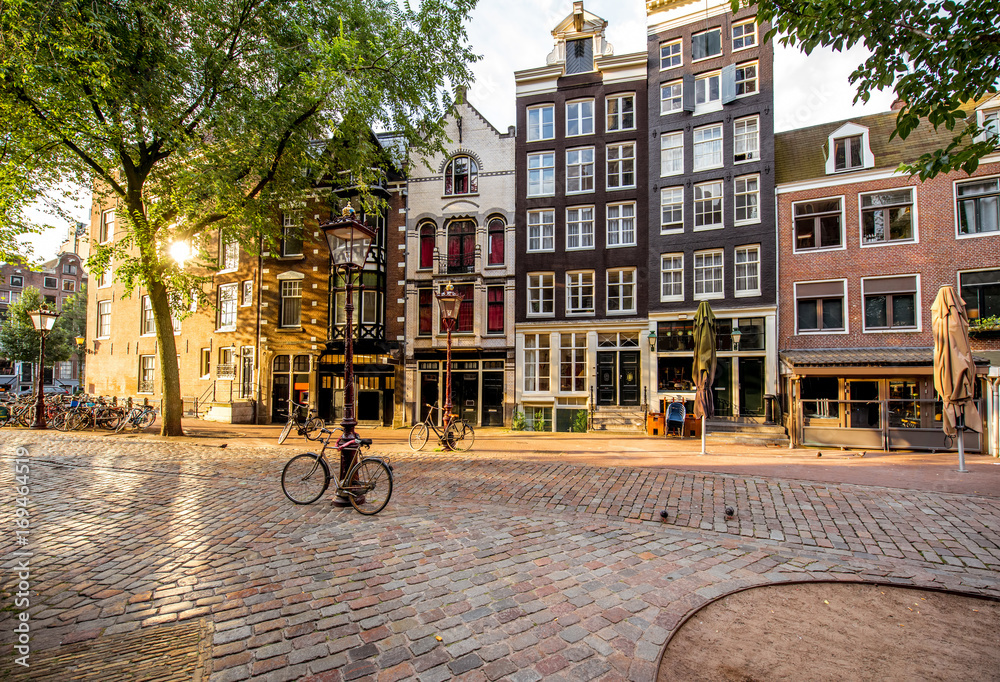 Morning view on the square with beautiful buildings near the Old Church in Amsterdam city