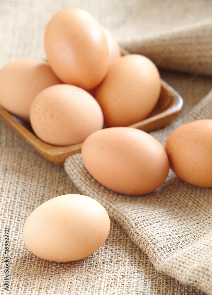 Pile of Brown fresh egg on brown fabric