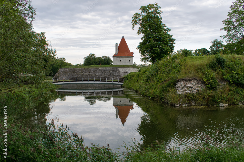 Castle tower and a bridge reflected in the river, Saaremaa