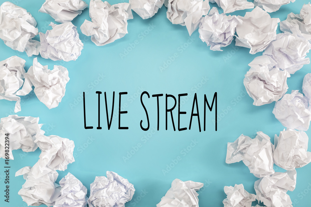 Live Stream text with crumpled paper balls on a blue background