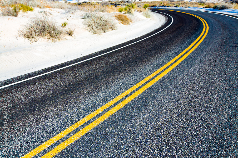 Yellow stripes on asphalt road