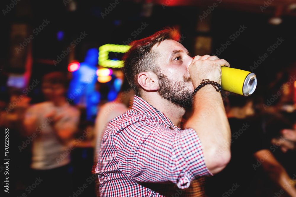 Closeup of a man and beer night time with long exposure technique