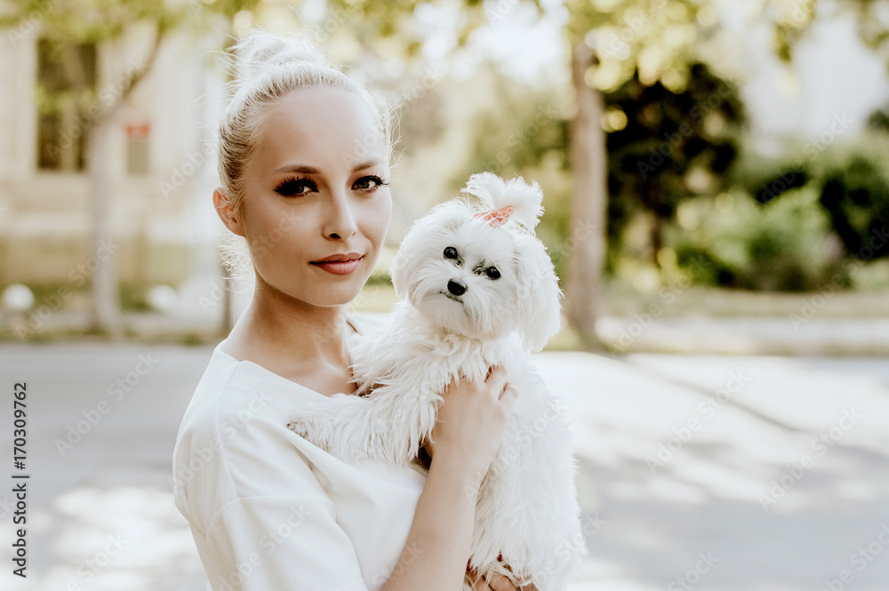 Portrait of young woman with a maltese dog