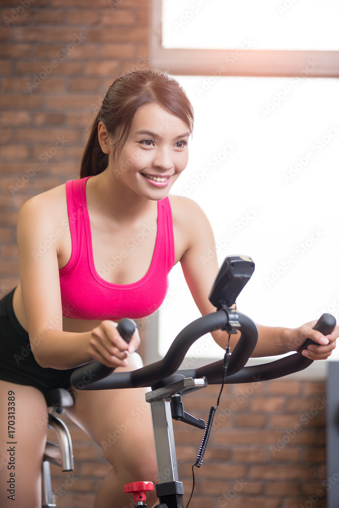 woman use exercise bike