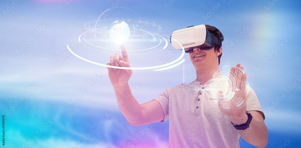 Composite image of smiling young man using virtual reality