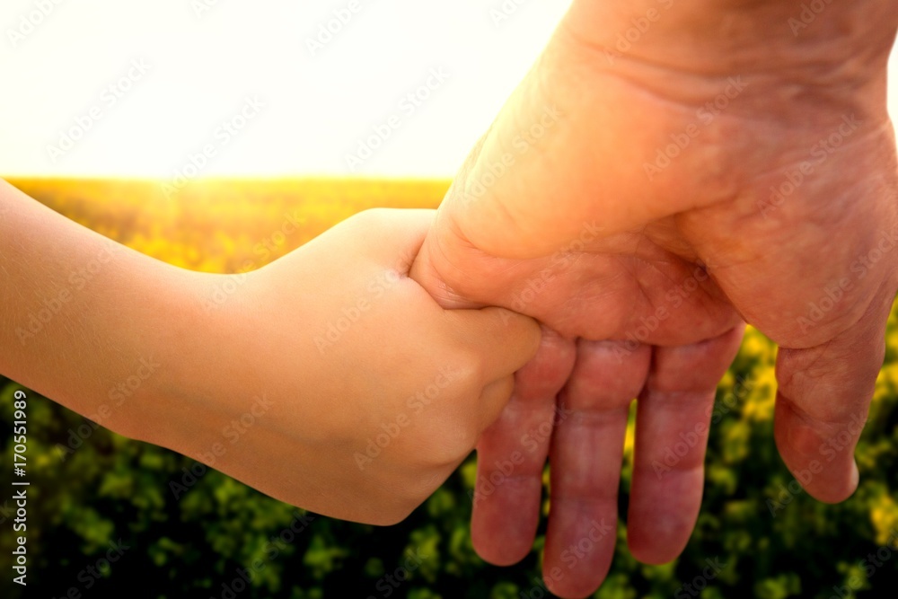 Father and child holding hands