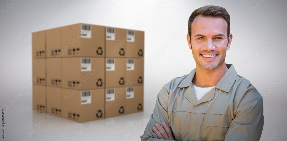 Composite image of confident delivery man standing with arms