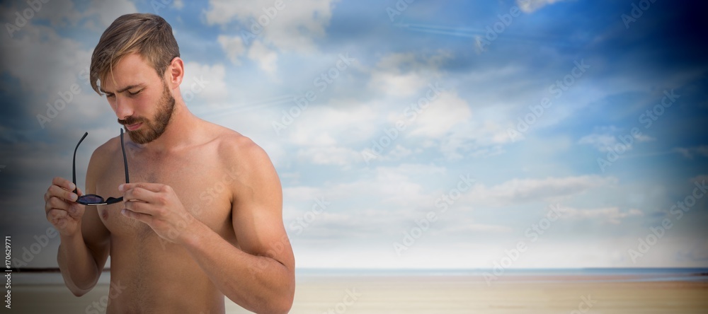 Composite image of handsome man wearing hat sunglasses 