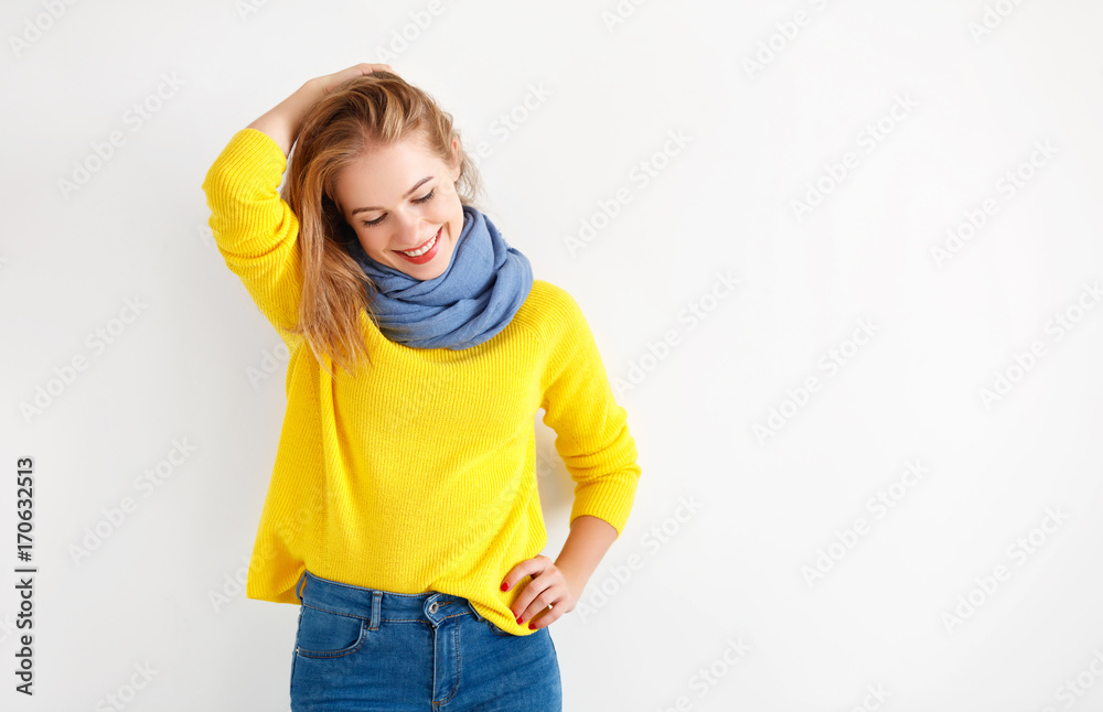 happy young woman in yellow sweater on white background.