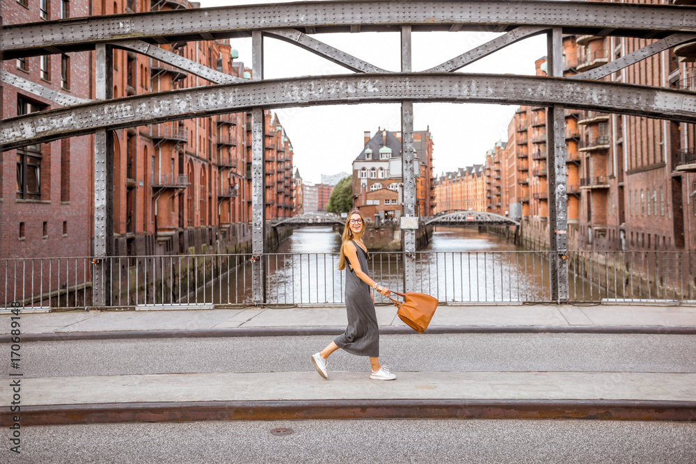 美丽的铁桥，一位女士走在德国汉堡历史悠久的仓库区Speicherstadt