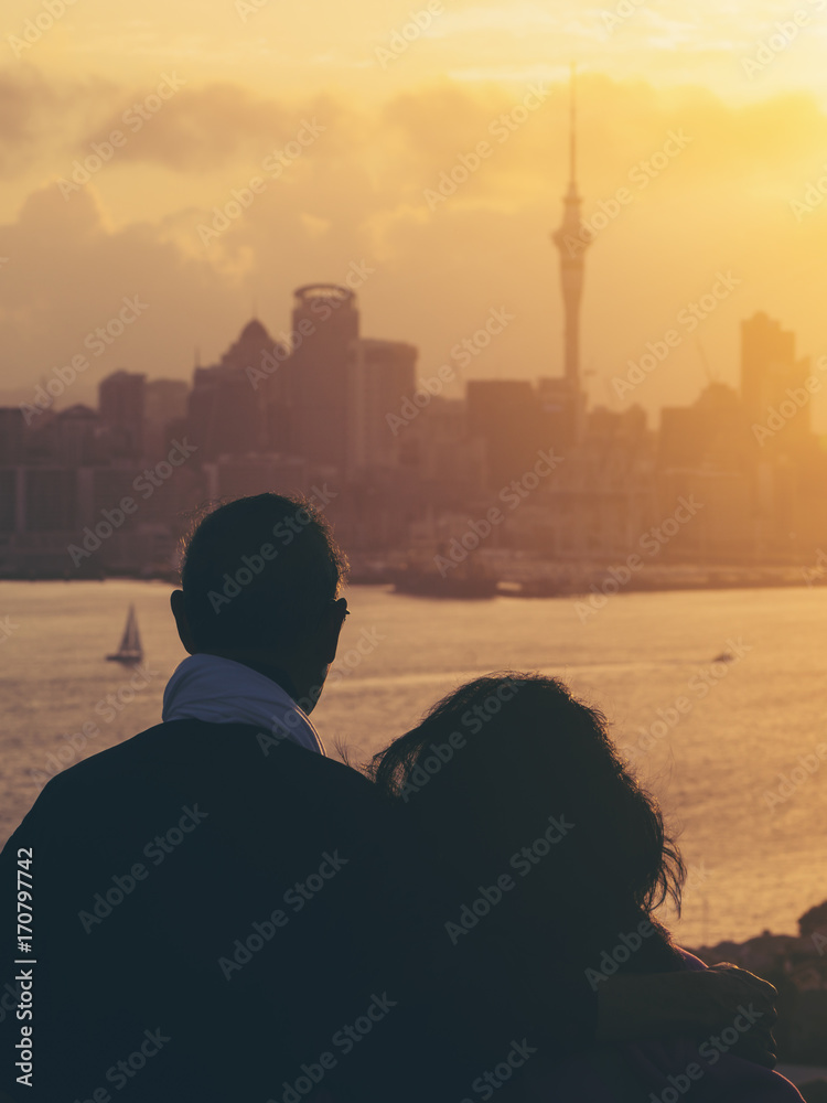 Happy senior couple watching sunset in Auckland