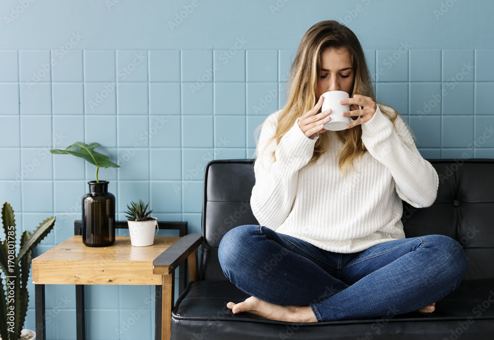 Caucasian woman sitting and drinking coffee