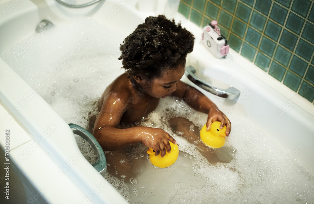 African descent kid enjoying bath tub