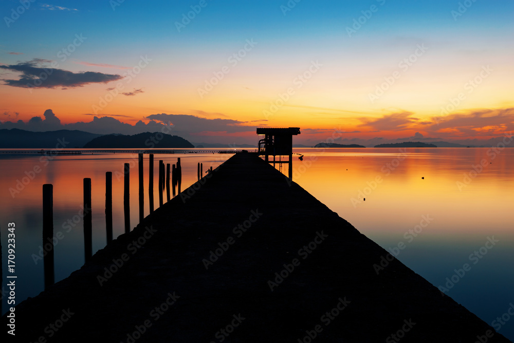 scenery view of old jetty to the sea beautiful sunrise or sunset in phuket thailand.