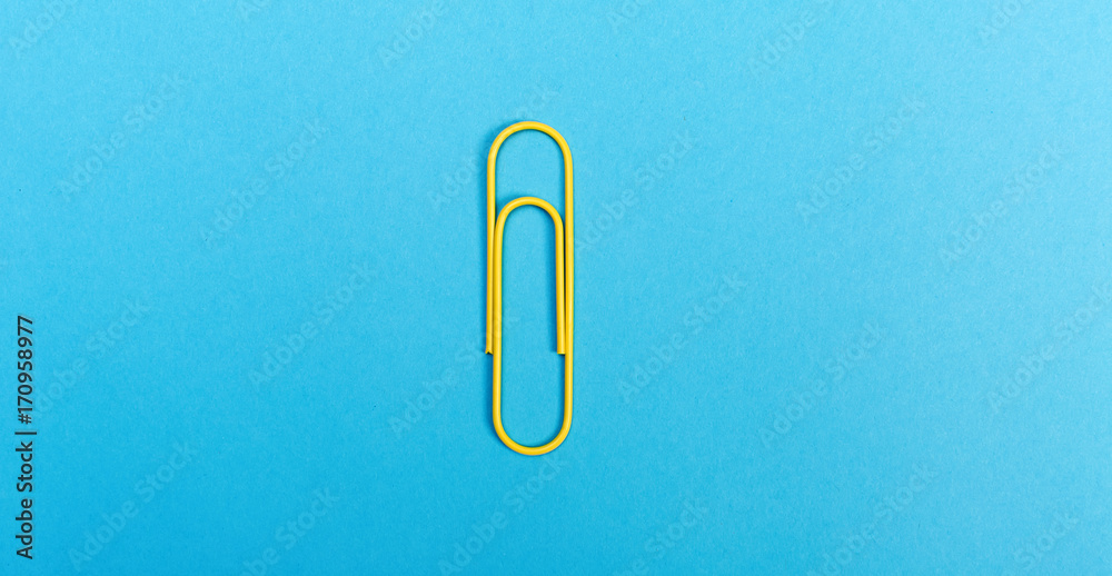 Big paper clip on a bright blue background