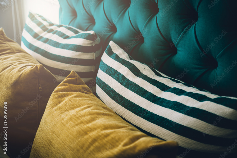 Bed maid-up with clean white pillows and bed sheets in beauty room. Close-up. Lens flair in sunlight