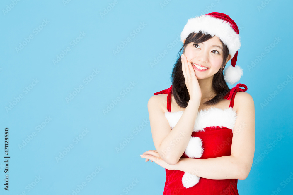 portrait of asian santa woman isolated on blue background