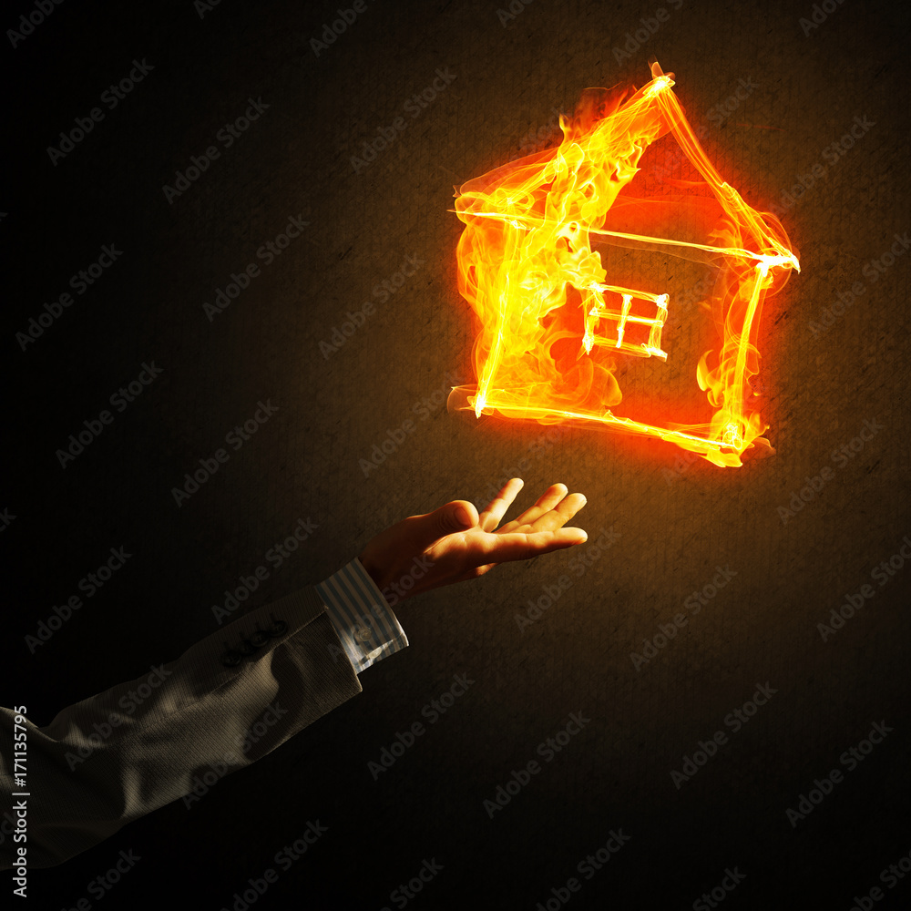 Businessman hand pointing at burning fire symbol