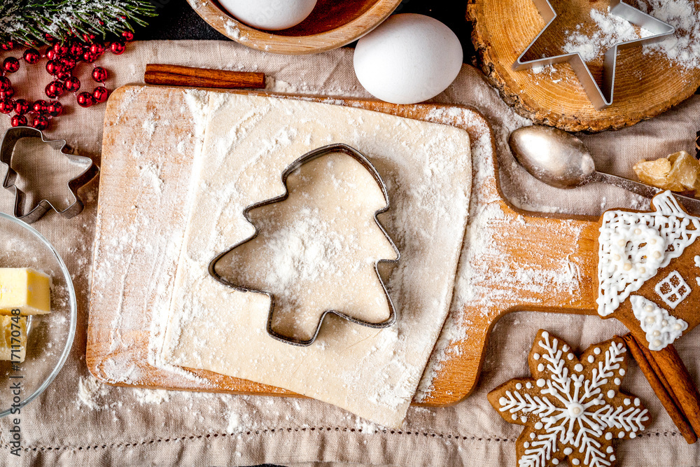 cooking christmas gingerbread on wooden background top view