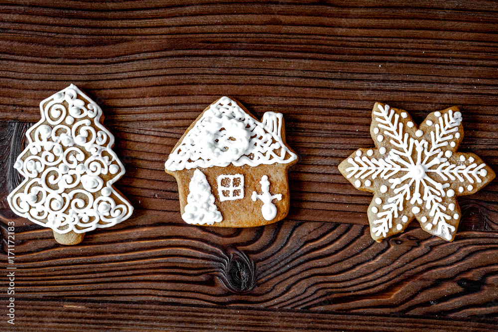 Christmas gingerbread on dark wooden background top view