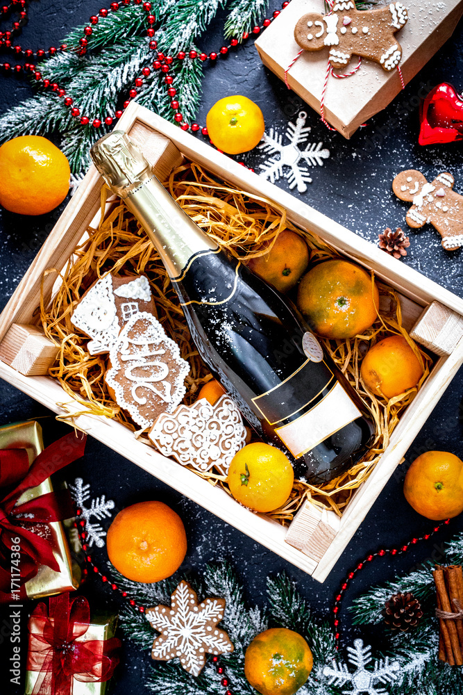 New Years champagne and tangerines in box top view