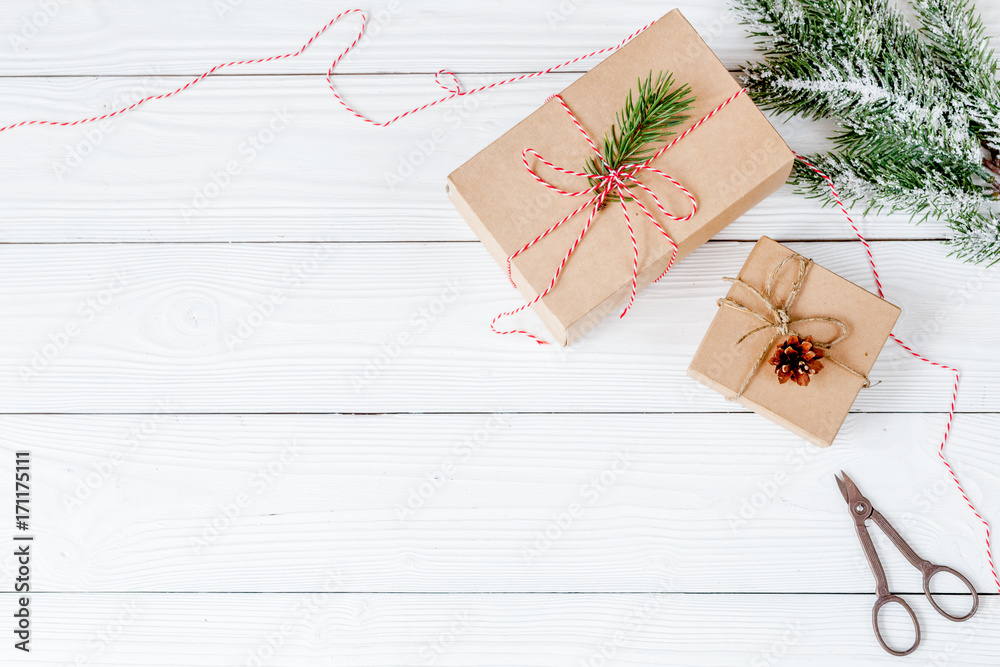 gifts boxes with fir branches on wooden background top view