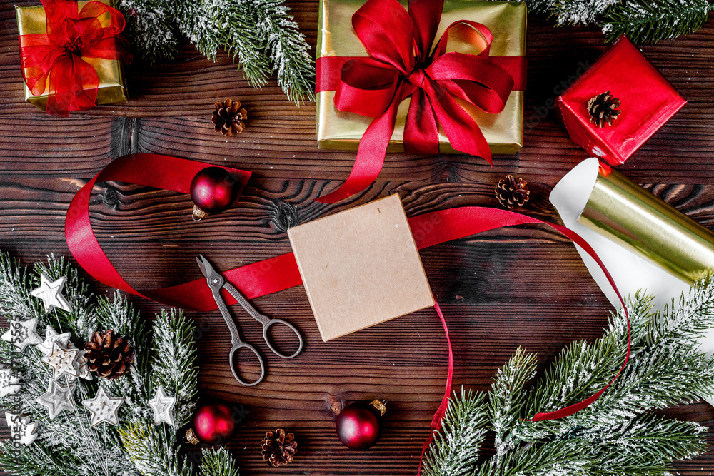 gifts boxes with fir branches on wooden background top view