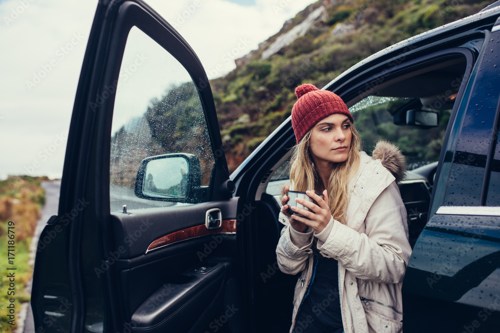 Female on road trip having coffee