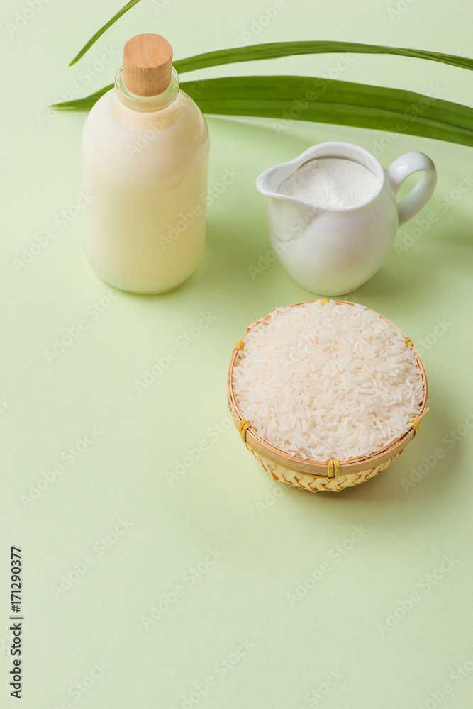 Milk and rice in bowl on light background.