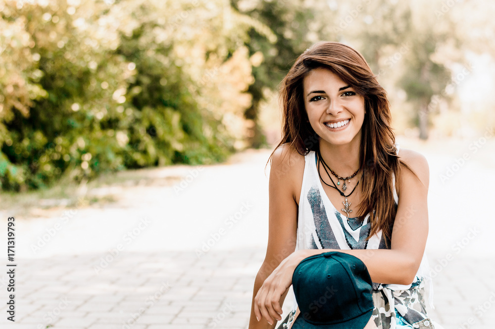 Portrait of a cheerful young brunette woman smiling