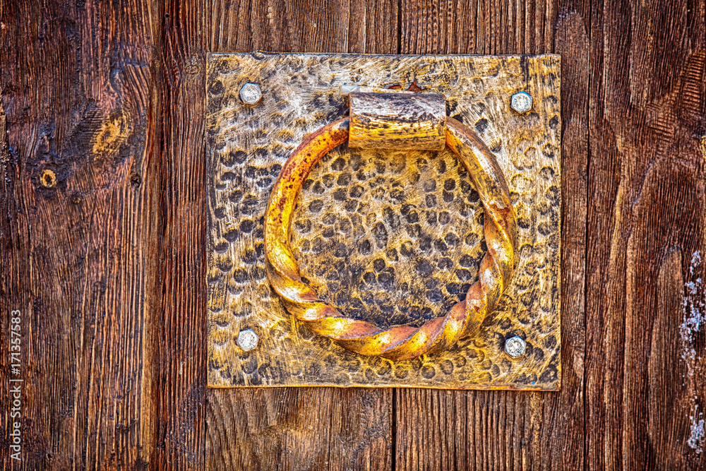 old metal handle on a wooden door