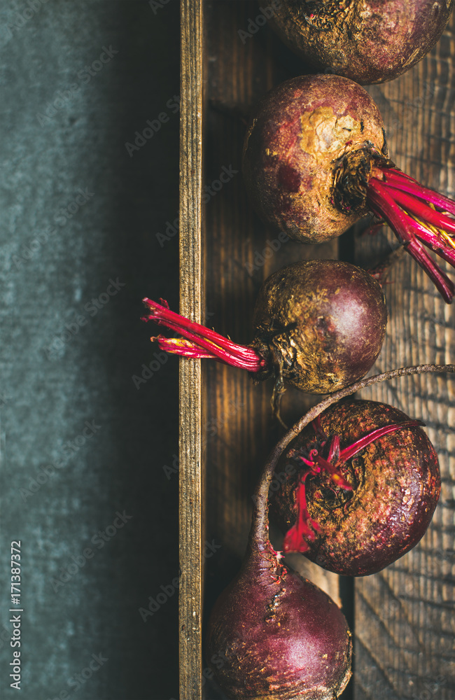 Raw organic purple beetroots in rustic wooden box, selective focus, top view, copy space