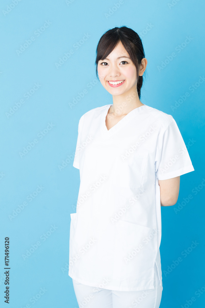 portrait of asian nurse isolated on blue background