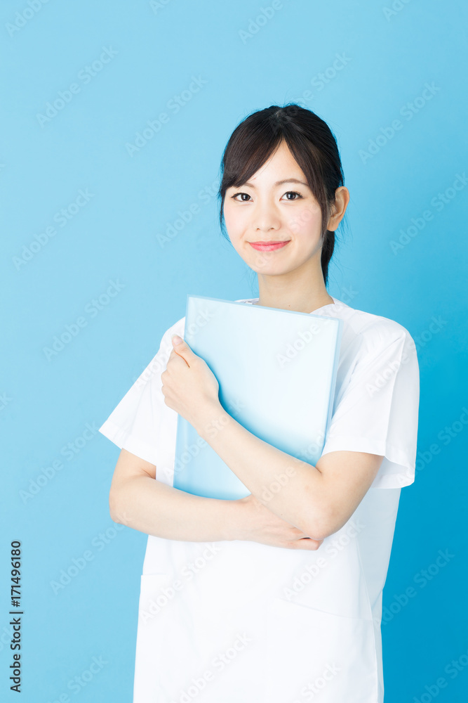 portrait of asian nurse isolated on blue background