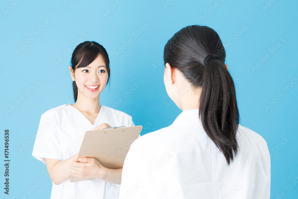 portrait of asian nurse isolated on blue background